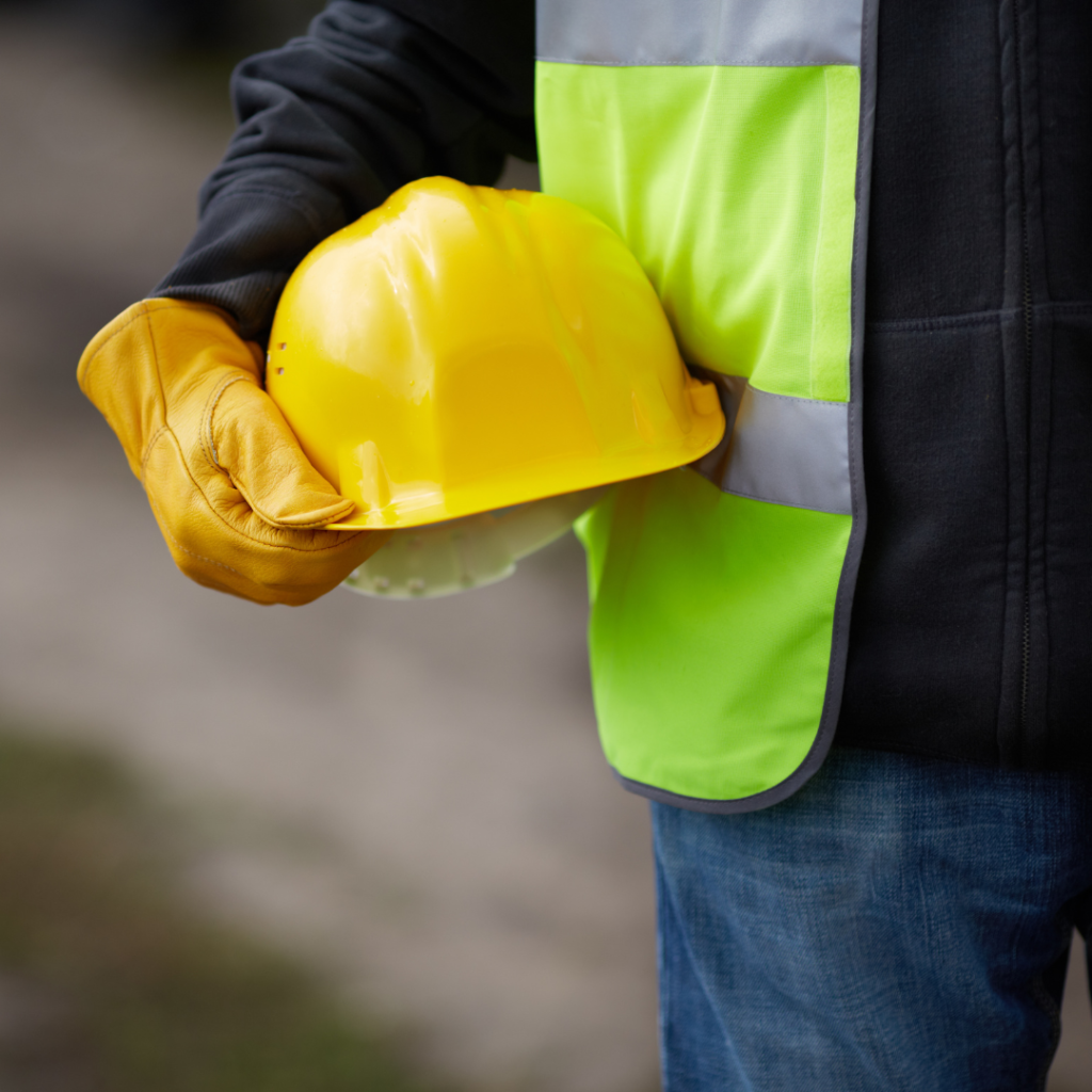 man holding yellow construction helmet