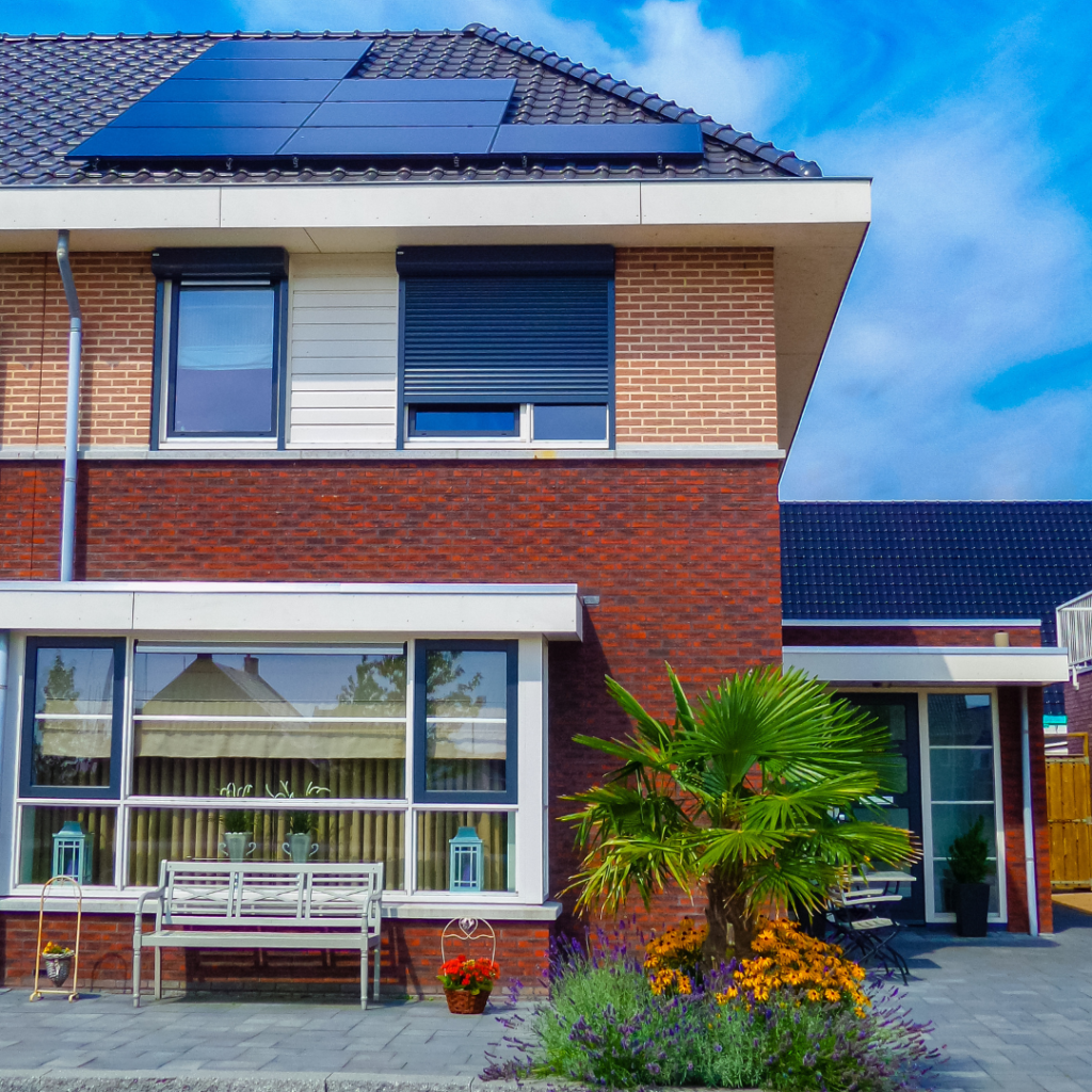 Newly build houses with solar panels attached on the roof against a sunny sky